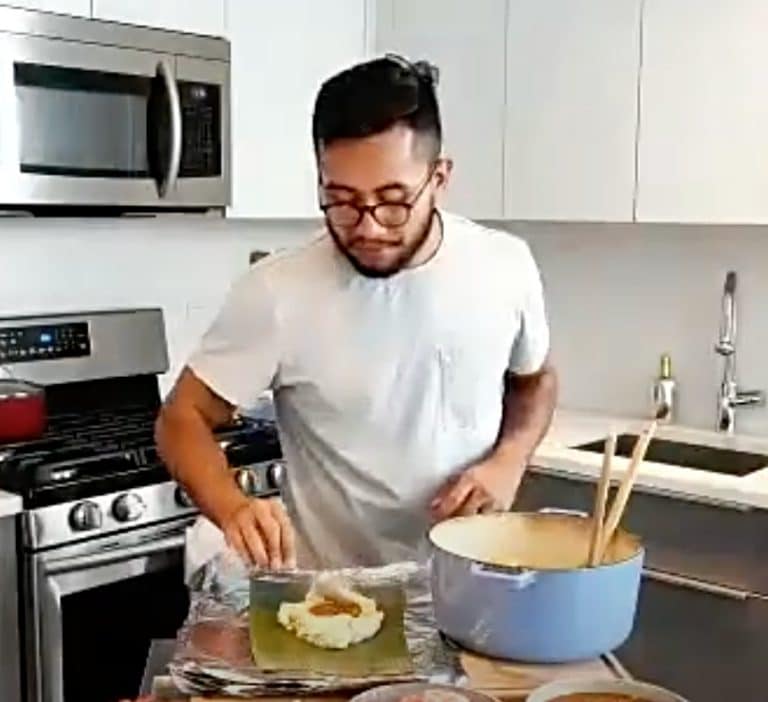 Luis fills the tamales with red recado sauce