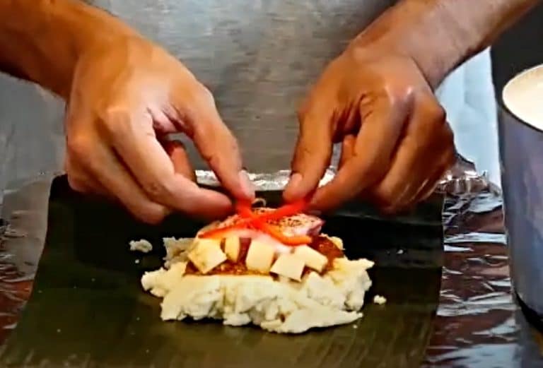 Luis adds the potato and red pepper to Guatemalan tamales 
