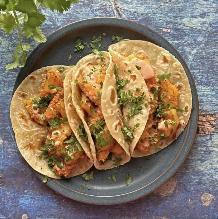 Baja fish tacos with pineapple and chipotle spicy sauce.