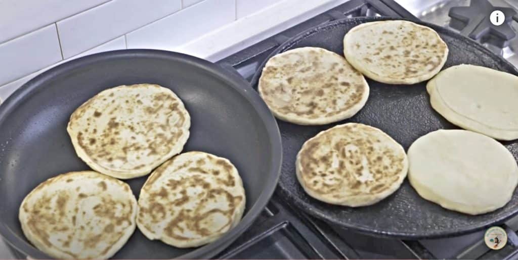 Toast the arepas on a budare or hot griddle