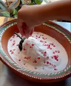 Chiles en nogada sprinkling pomegranates